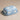 Blue Cloud Butter Dish with the lid on, on a beige surface