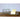 Pressed glass butter dish holding a stick of butter on a wooden table