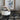 White pot on a gas stove with floral artwork in the background