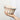 A hand holding a traditional bundt cake pan with a floral pattern in blue and white colors.