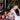 Hands folding a red striped linen napkin at a set table