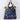 Hand carrying the Nordic Ski navy bag filled with flowers