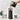 Pouring coffee beans from a bag into the hopper of the OXO Brew burr grinder on a kitchen counter