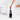 Hand lifting the Matt Steel ReNew toilet brush from its holder beside a toilet