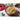 Le Creuset 5.5-quart round Dutch oven with vibrant enamel coating and sturdy lid for versatile cooking.