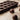 A brown silicone chocolate mold with 18 truffle shapes, with some chocolate truffles placed inside and outside of the mold on a textured surface.
