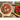 Baked pizza resting on the Fantes wood pizza peel next to tomatoes and basil