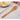 Olive wood pierced spatula standing in a countertop utensil crock