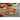Baked pizza on the HIC 13 inch pizza stone with vegetables around it