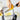 Microplane Zester and Grater with stainless steel surface and ergonomic handle for citrus zest and fine grating.