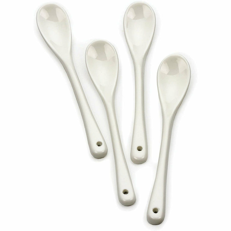 White porcelain egg spoon resting on a table