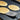 Tovolo slotted turner flipping pancakes on a griddle
