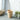 UMBRA Woodrow trash can in black with a sleek cylindrical design, featuring a wooden lid for modern kitchen organization.