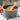 Olivewood spoon stirring tomato sauce in a saucepan