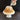 Glaze being poured over a lotus-shaped Bundt cake on a cake stand