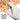 Oxo silicone oven mitt in gray with textured grip, heat-resistant for safe handling of hot cookware in the kitchen.