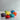 Le Creuset mini cocotte souffle dish in vibrant color, showcasing its round shape and durable enameled exterior.