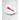 Red GIR Ultimate Basting Brush resting on a folded white napkin on a white plate, marble counter