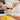 Hands peeling a carrot with the OXO swivel peeler over a cutting board