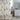 Yellow and gray Katsura PEVA shower curtain from MODA with a floral pattern, hanging in a bathroom setting.