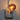 Kikkerland Moon Night Light glowing while plugged into a wall outlet