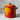 Le Creuset 8-quart stock pot in flame color with sturdy handles and a tight-fitting lid for soups and broths.