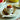 Porcelain egg spoon scooping a soft boiled egg from its shell