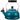 Le Creuset whistling tea kettle with a vibrant red enamel finish and stainless steel handle on a stovetop.