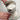 Hands turning the crank on the RSVP flour sifter over a glass bowl