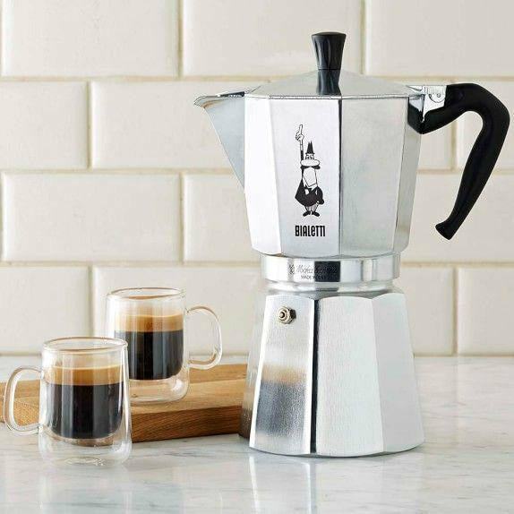 Bialetti Moka Express stovetop espresso maker with polished aluminum body and black handle, ready for brewing espresso.