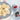 Plate of pleated star and floral shortbread cookies beside two Nordic Ware cookie stamps with red handles