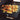 Emile Henry rectangular stone on a grill with vegetables cooking