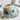 Le Creuset 1.75-quart iron handle sauce pan with black handle and stainless steel lid on a stovetop.