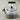 Le Creuset whistling tea kettle with a vibrant enamel finish and stainless steel handle, ready on a stovetop.