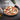 Pizza on the Emile Henry stone carried with oven mitts