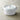 Staub round cocotte showing brass knob and self-basting lid