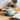 Le Creuset mini cocotte souffle dish in vibrant color, with a round shape and smooth enamel finish, suitable for individual servings.